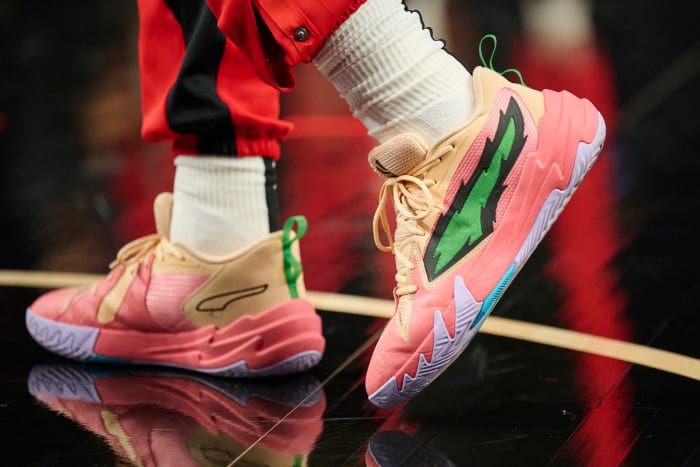 Portland Trail Blazers guard Scoot Henderson's pink and green PUMA shoes.